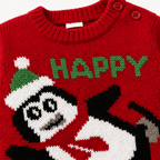 Dettaglio tessuto maglione natalizio rosso neonato pinguino e scritta HAPPY